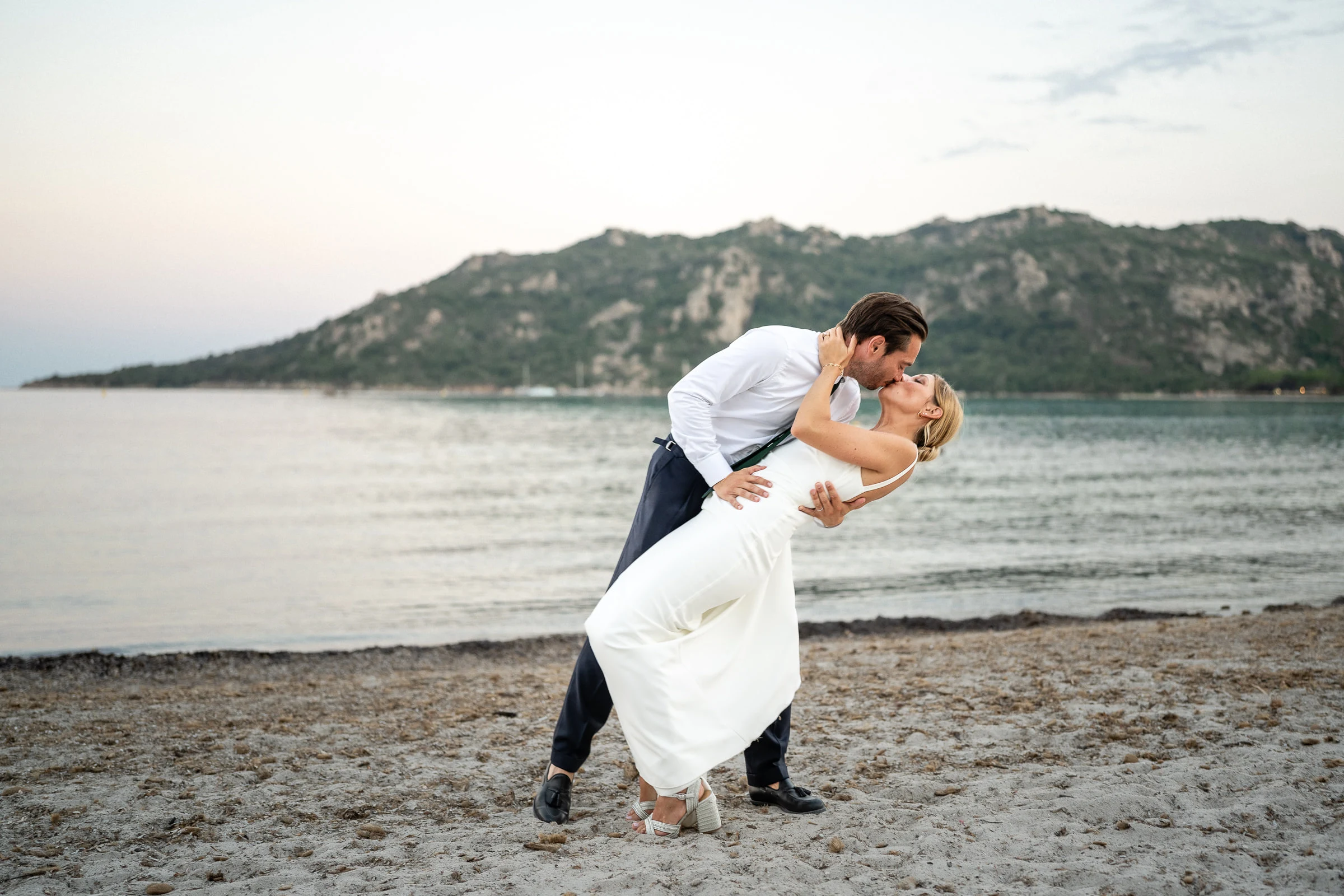 Le marié renverse la mariée sur le sable, Santa Giulia