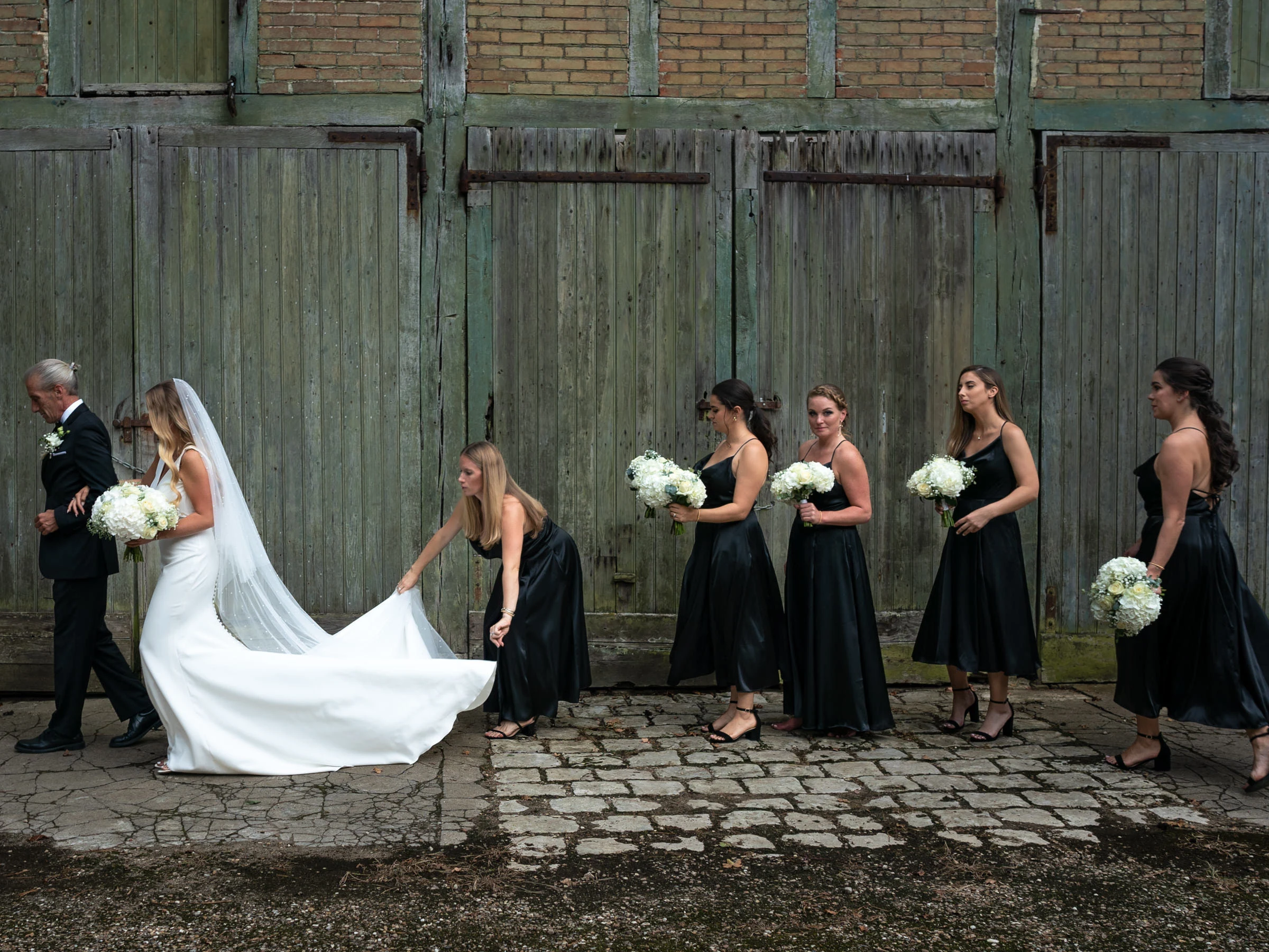The bridesmaids’ procession and the bride before the old doors, château du Pont-Chevron, Ouzouer-sur-Trézée