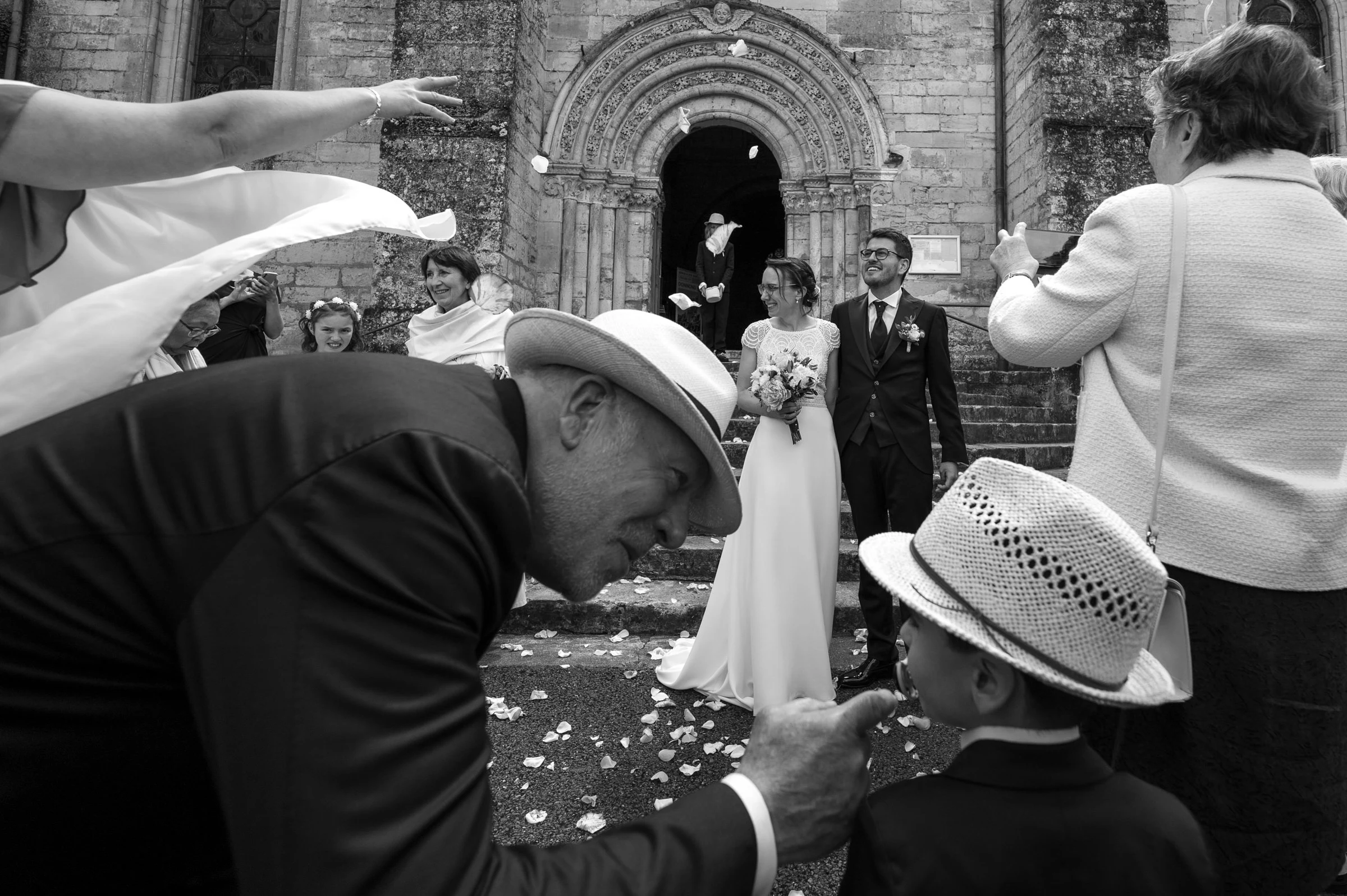 Leaving the church beneath the petals, black and white